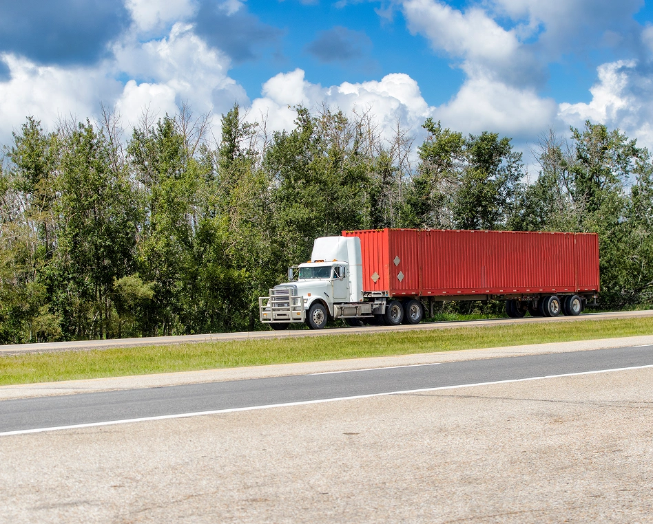 Red shipping container on a white truck