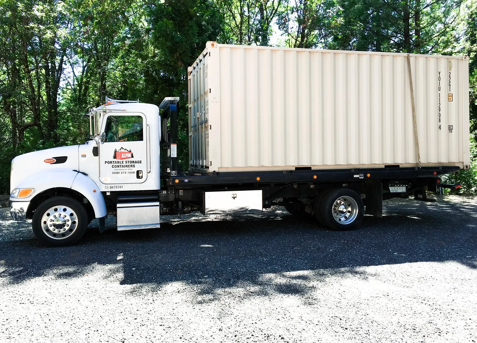 Truck carrying large shipping container
